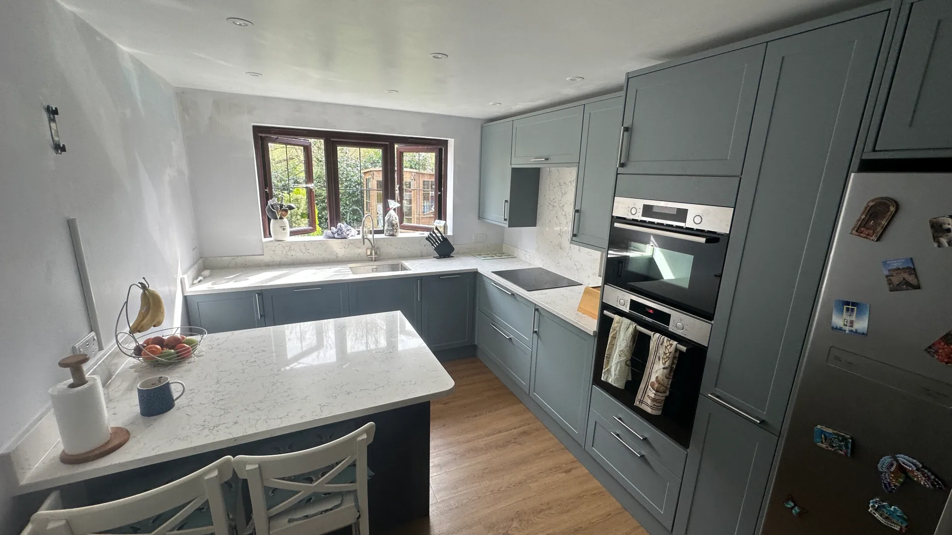 After — completed Burgess Hill kitchen renovation with modern shaker units and granite worktops