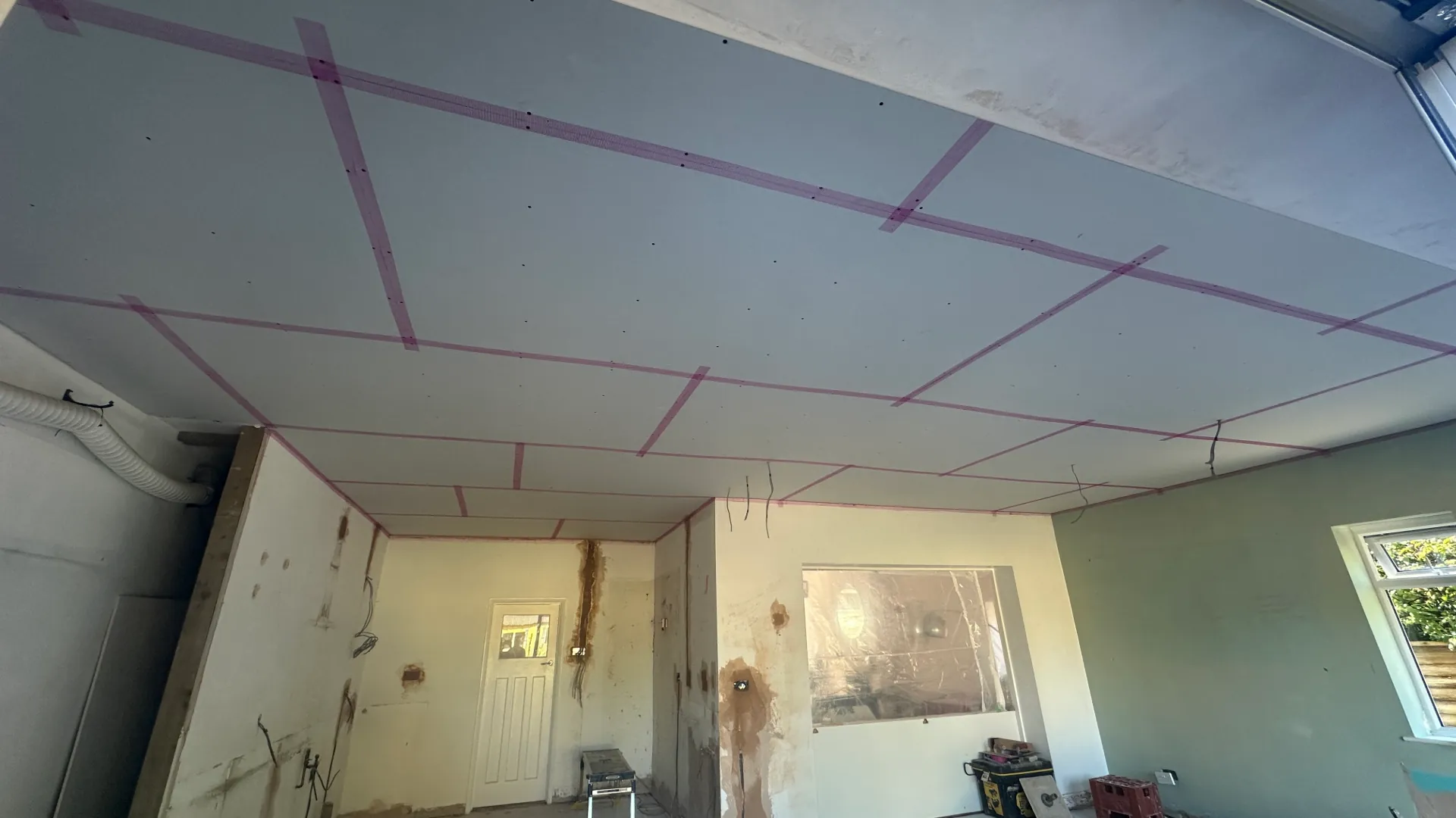 Before — boarded ceiling and walls in Lancing ready for plastering