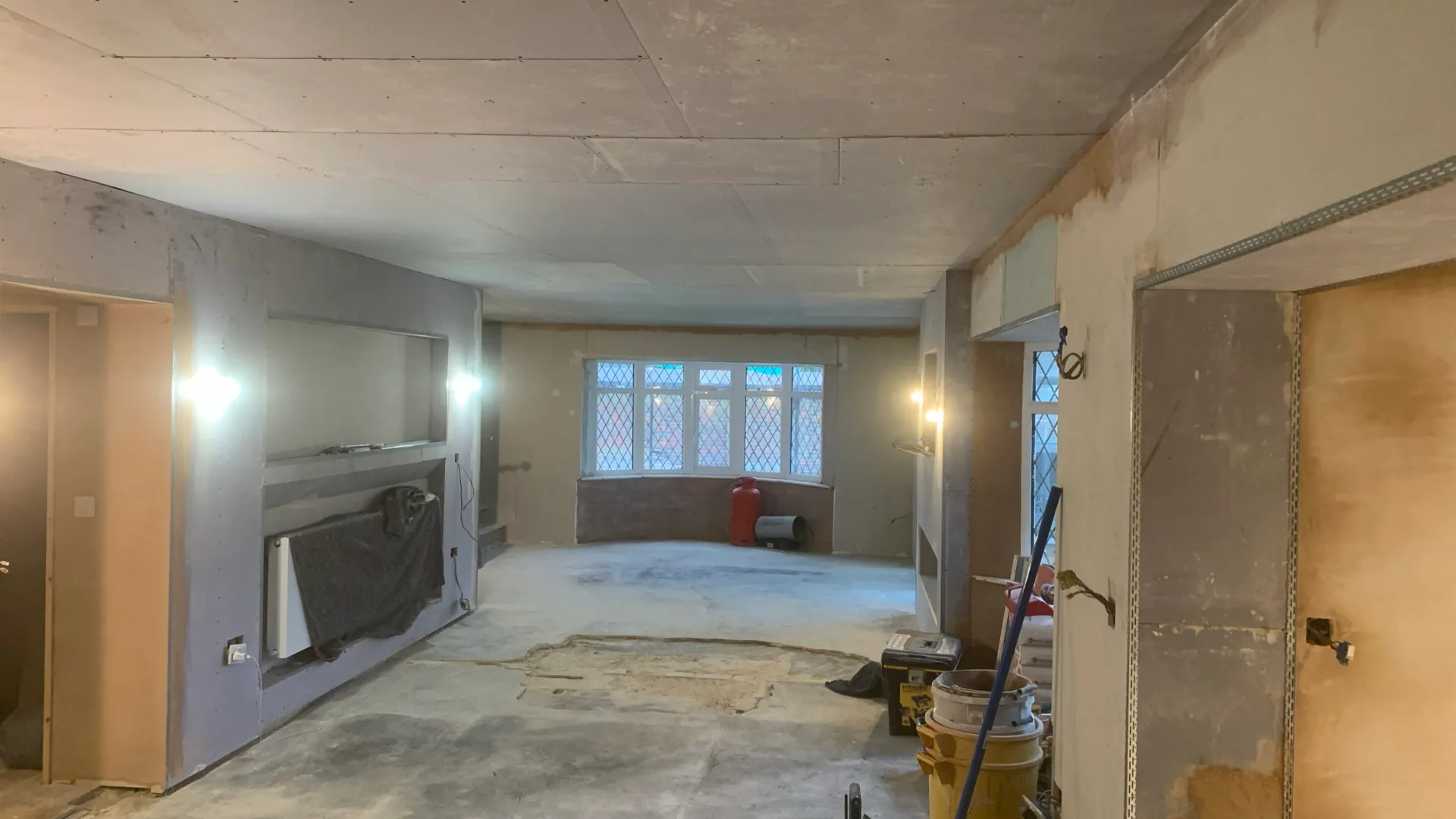 Before — large open-plan area in Seaford boarded and ready for plastering